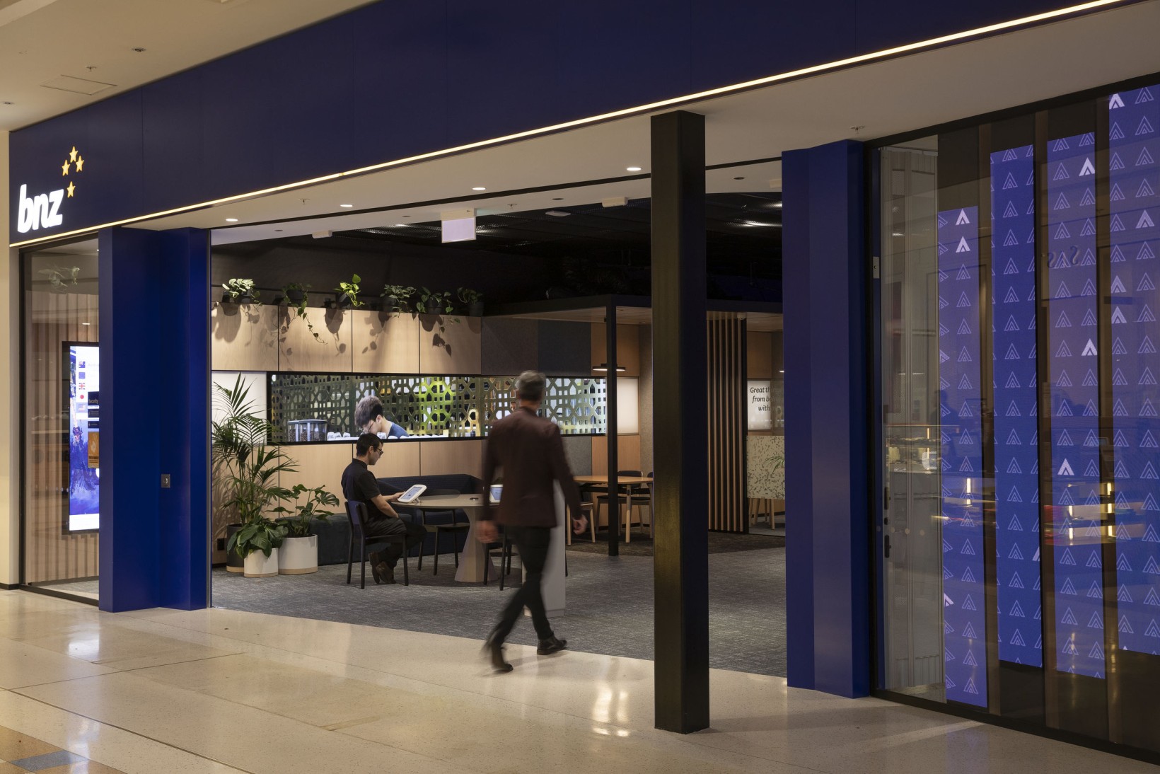 BNZ shopfront entrance in a mall, with palms and wall-mounted trailing plants visible inside the branch.