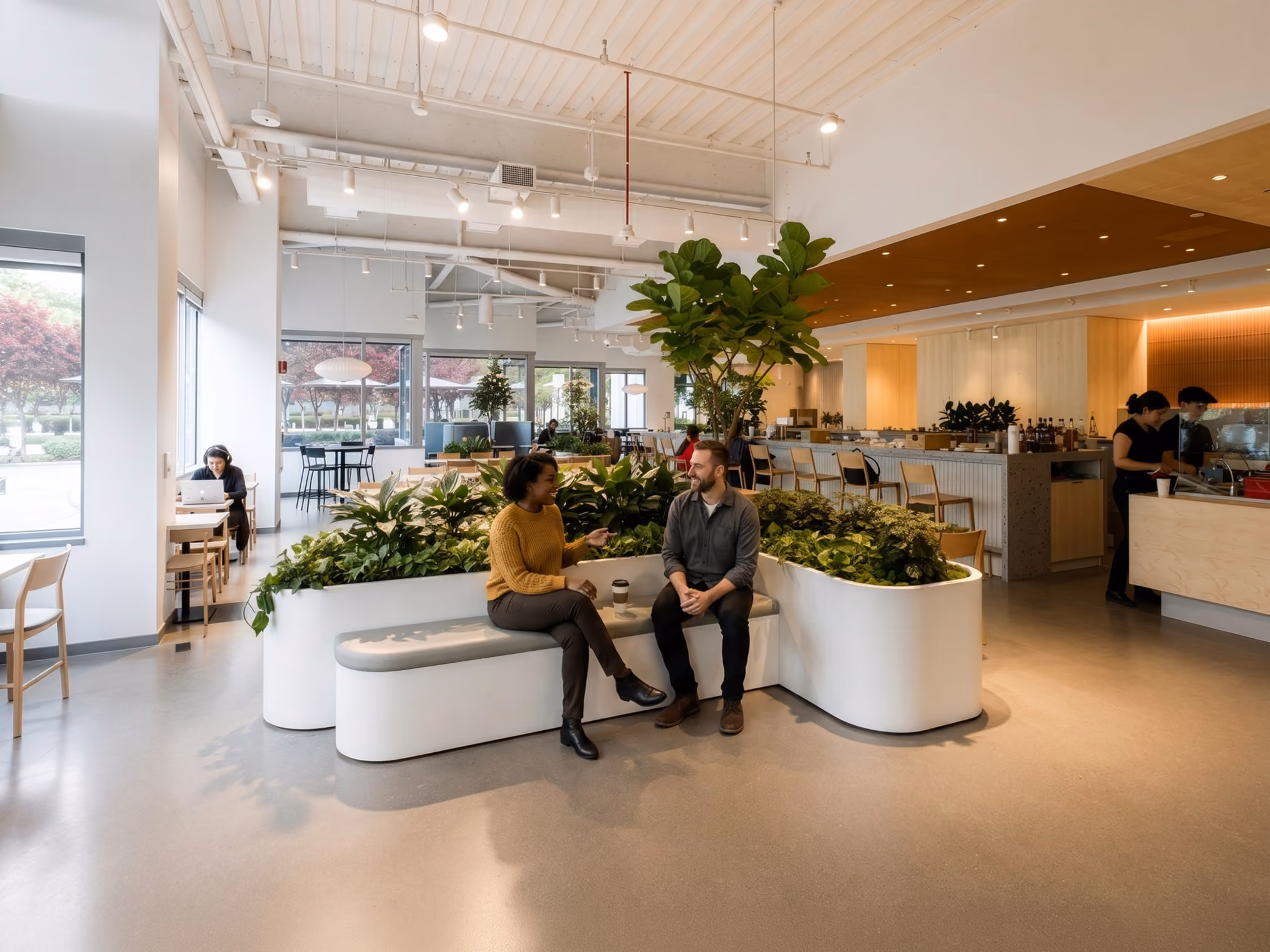 Two people sitting having a conversation at an open place office and cafe.