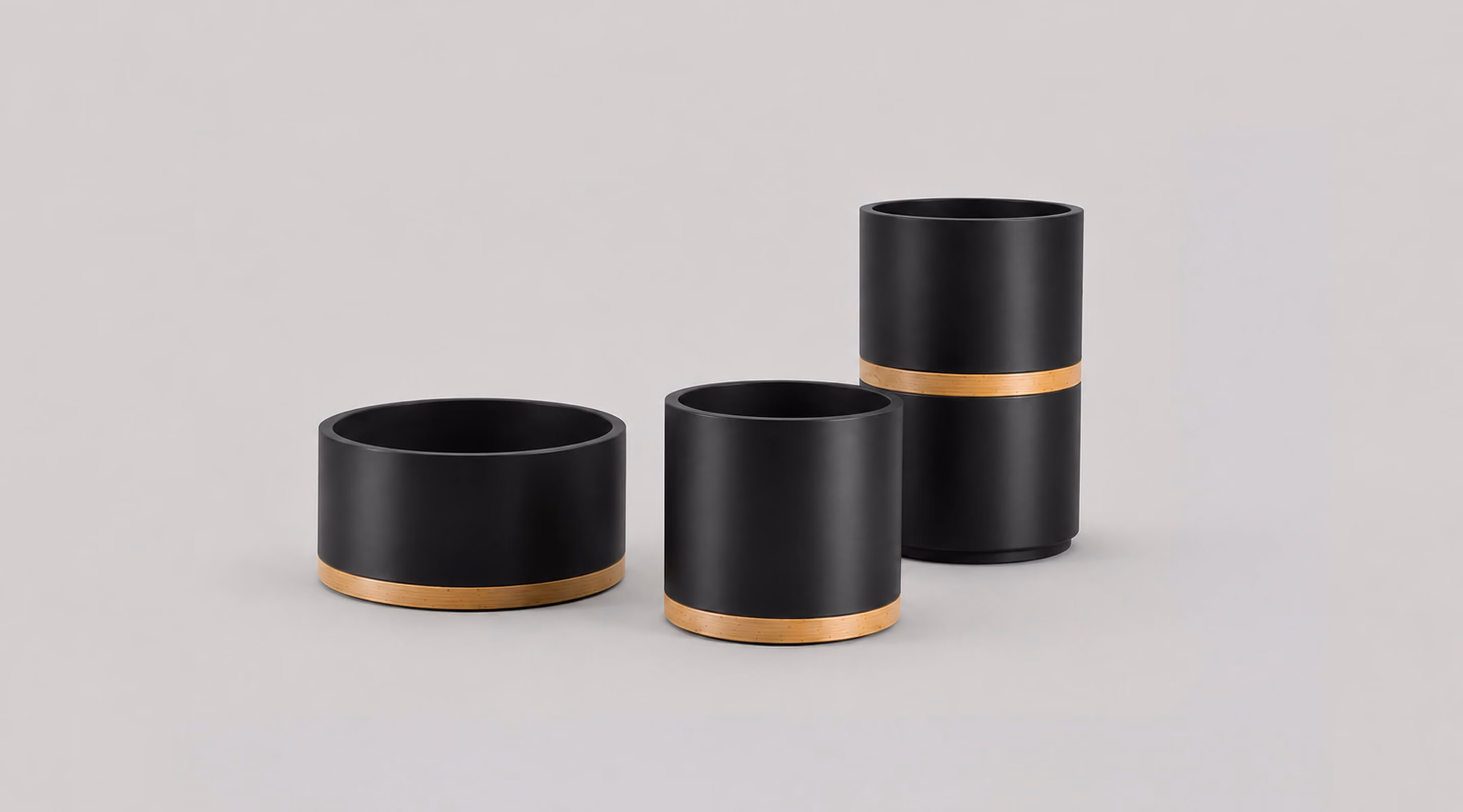 Three Strata cylindrical planters in black with brass rings