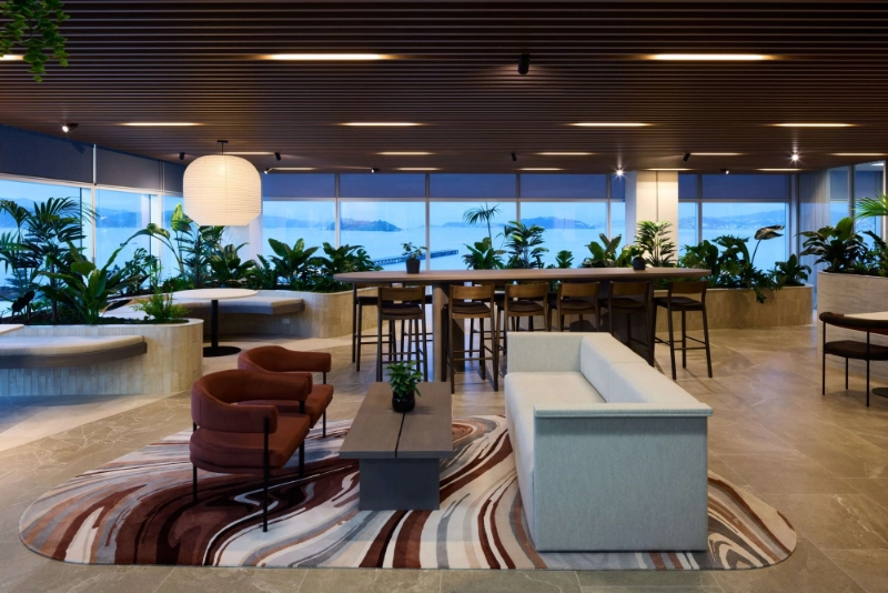 Curved planters of tropical plants around the SecuritEase breakout lounge and high bar