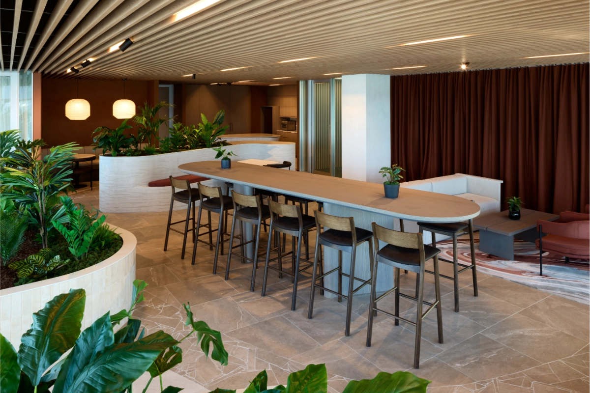 Long bar table with high stools beside curved planters at SecuritEase