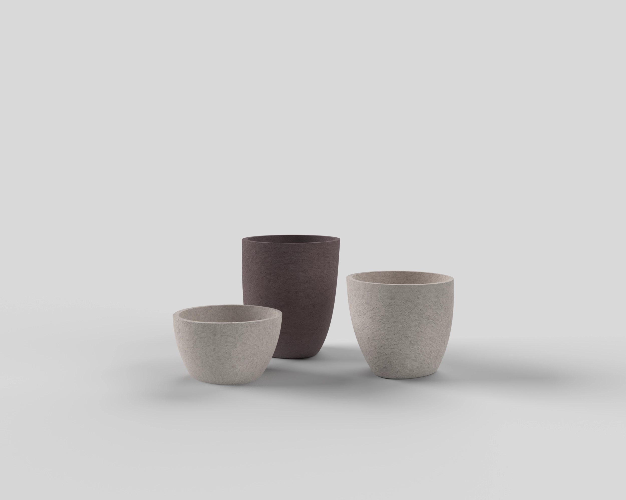 Three Terra Curve planters in grey and plum finishes