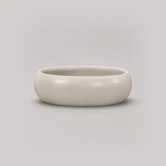 Drift wide, low oval planter in a pale stone finish