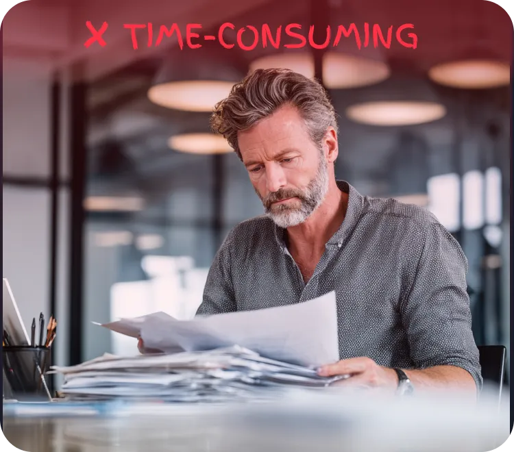 Older man with gray hair and beard reviewing a large stack of papers at a desk under red text that reads 'X TIME-CONSUMING'.