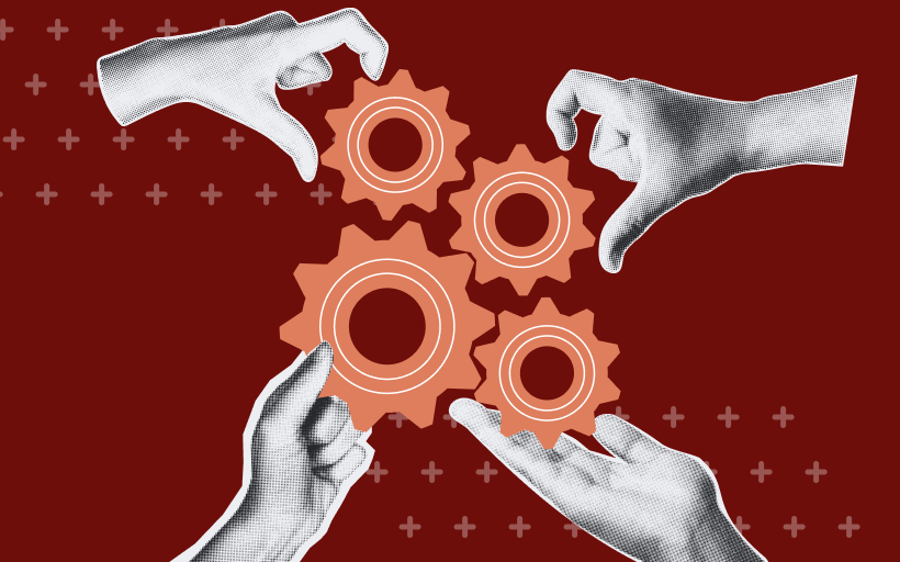 Four hands assembling gears together.