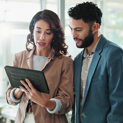 Tablet, discussion and business people in office with report