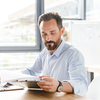 Middle aged caucasian man reading  document