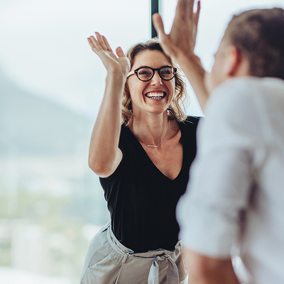 Businesswoman giving a high five to a colleague in meeting