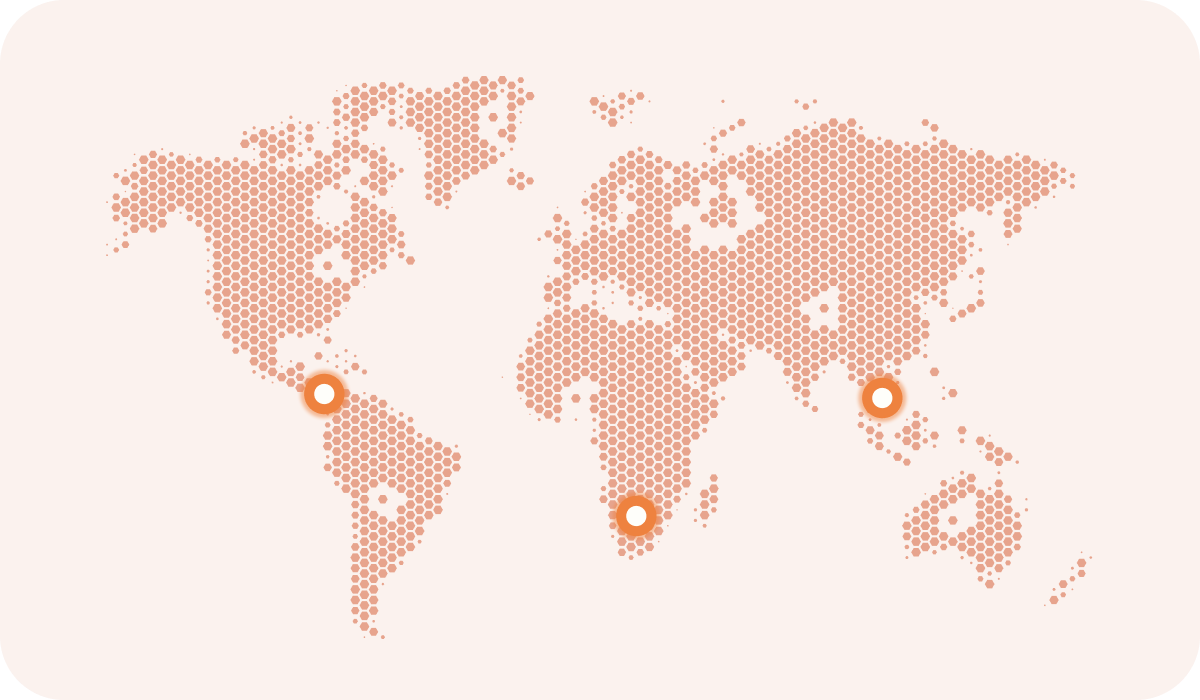 World map composed of hexagons with three orange circular markers in Central America, Southern Africa, and Southeast Asia.