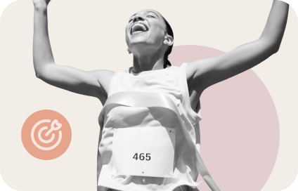 Joyful runner crossing finish line with arms raised and race bib number 465.