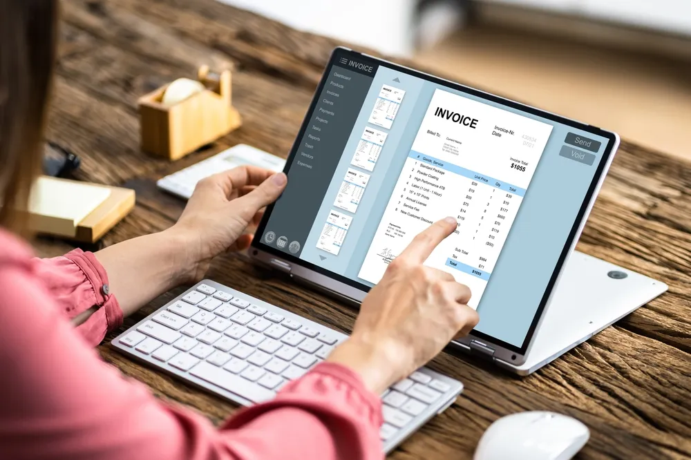 Woman looks at digital invoice