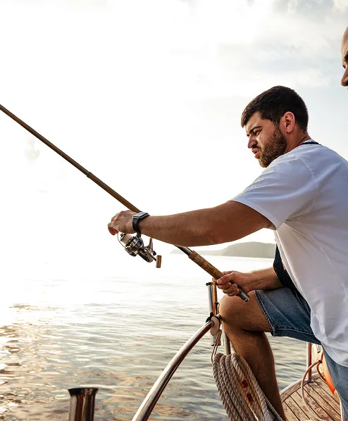 A young male with a fishing rod at the key