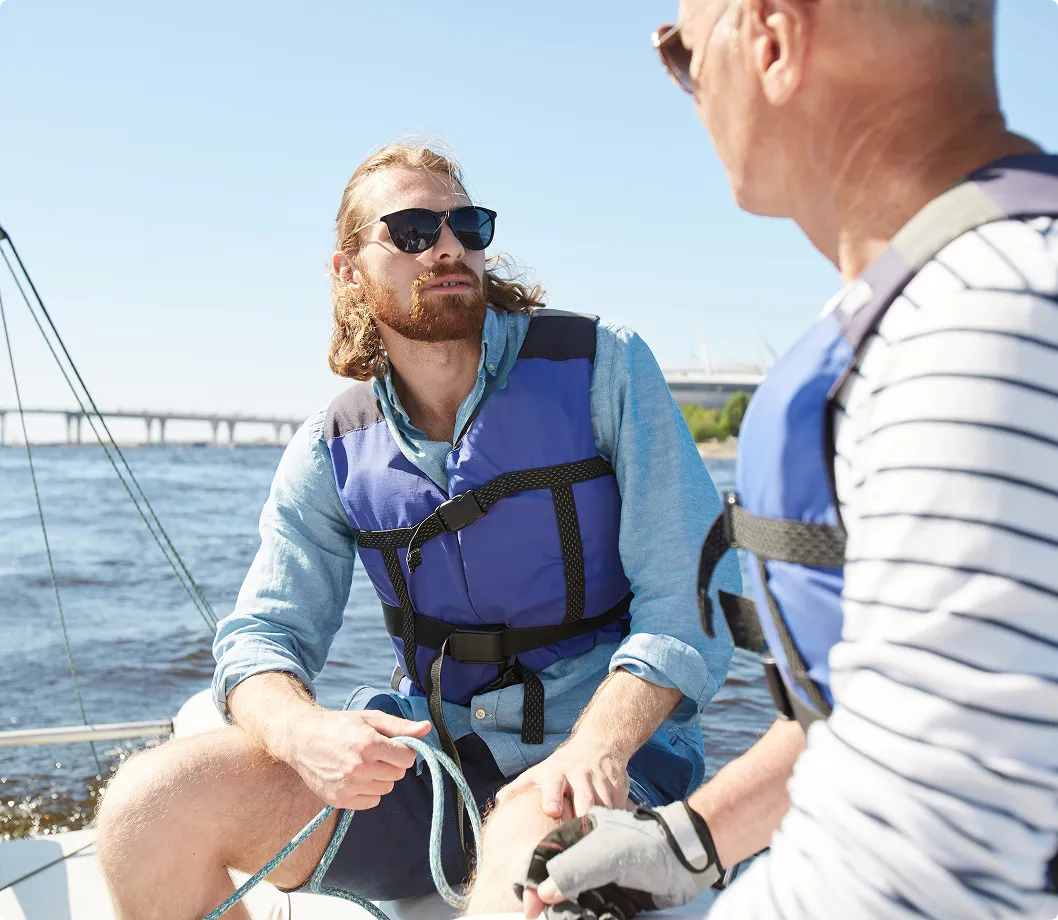 Two males on a boat looking at each other