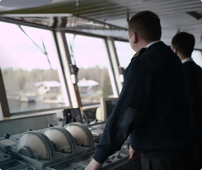Two people in the cabin controling the ship