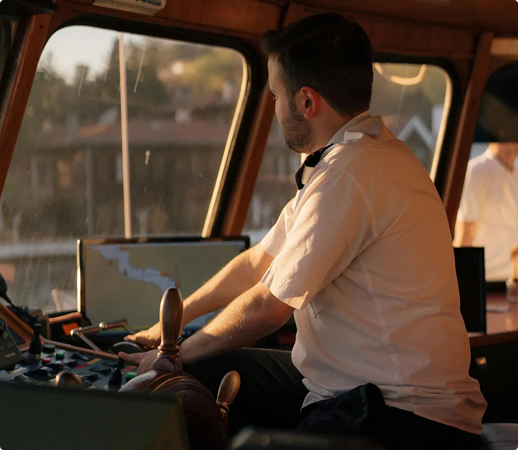 A male driving a boat