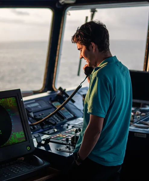 Person in a ship cabin talking on the phone