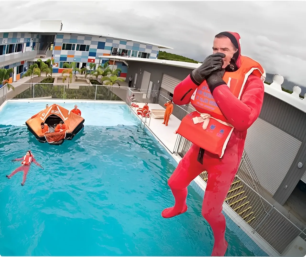 A male in a swimming suit jumping in a pool