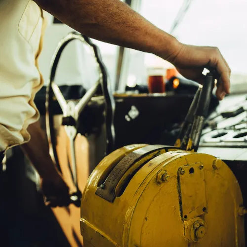 Boat Captain pushing the throttle forward on a tow boat