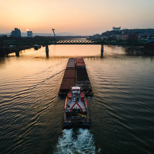 Tow boat pushing a barge down river