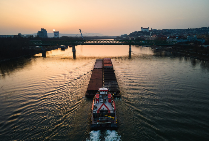 Tow boat pushing a barge down river