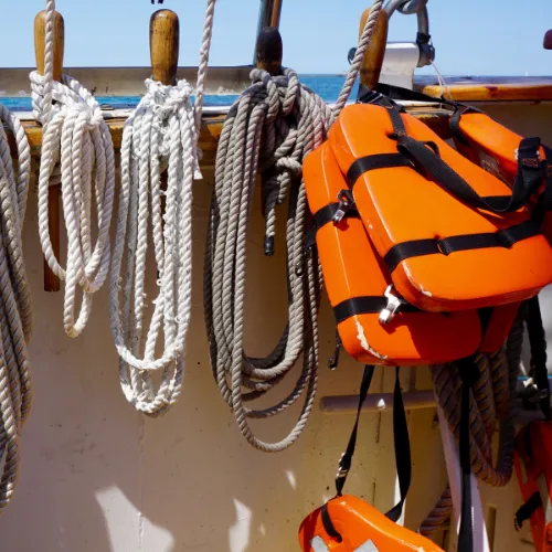 Lines of rope and personal floatation device on boat