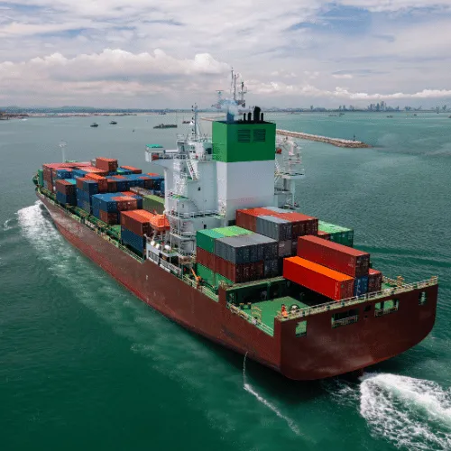 Cargo ship pulling into port on the water
