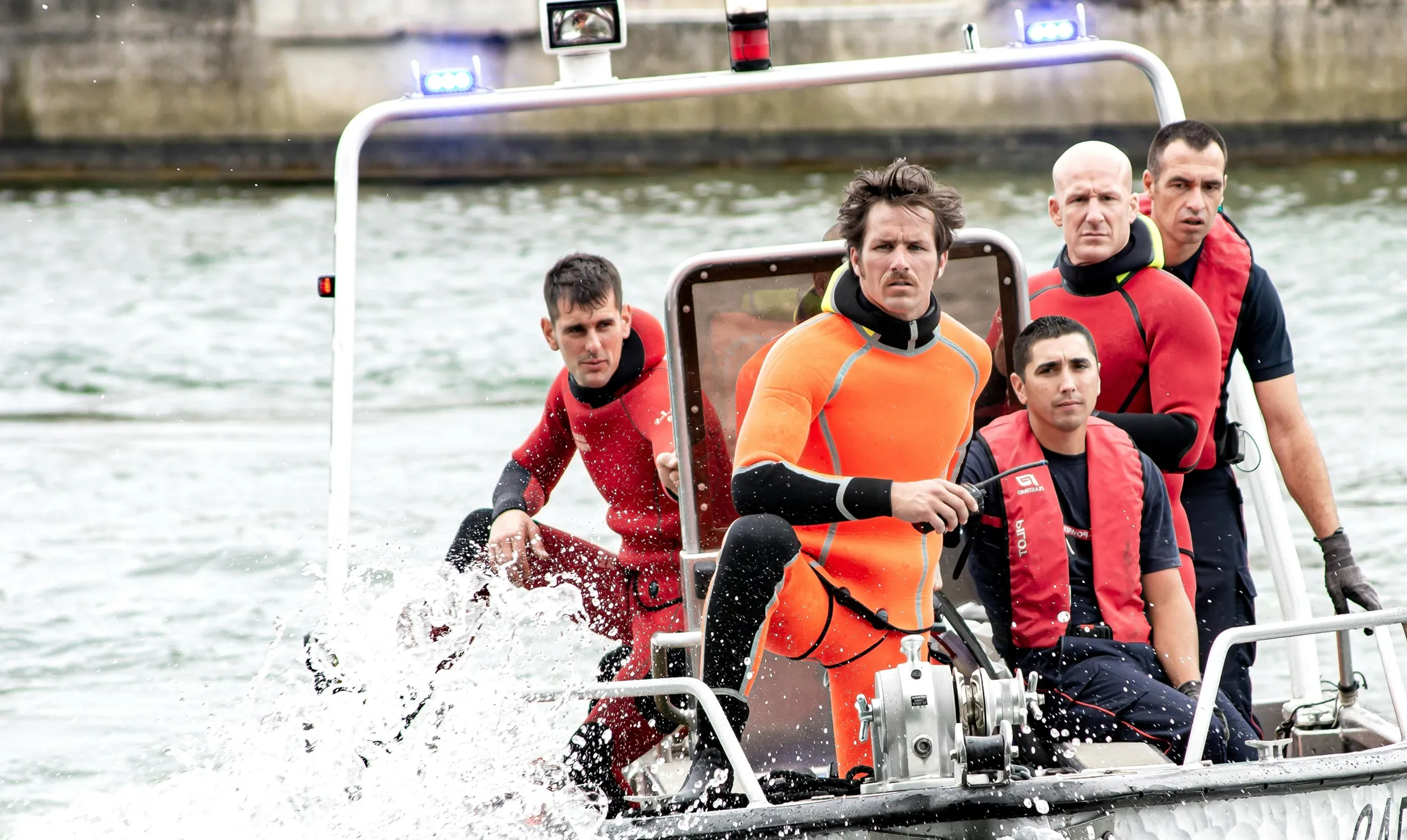 People on a boat in swimsuits.
