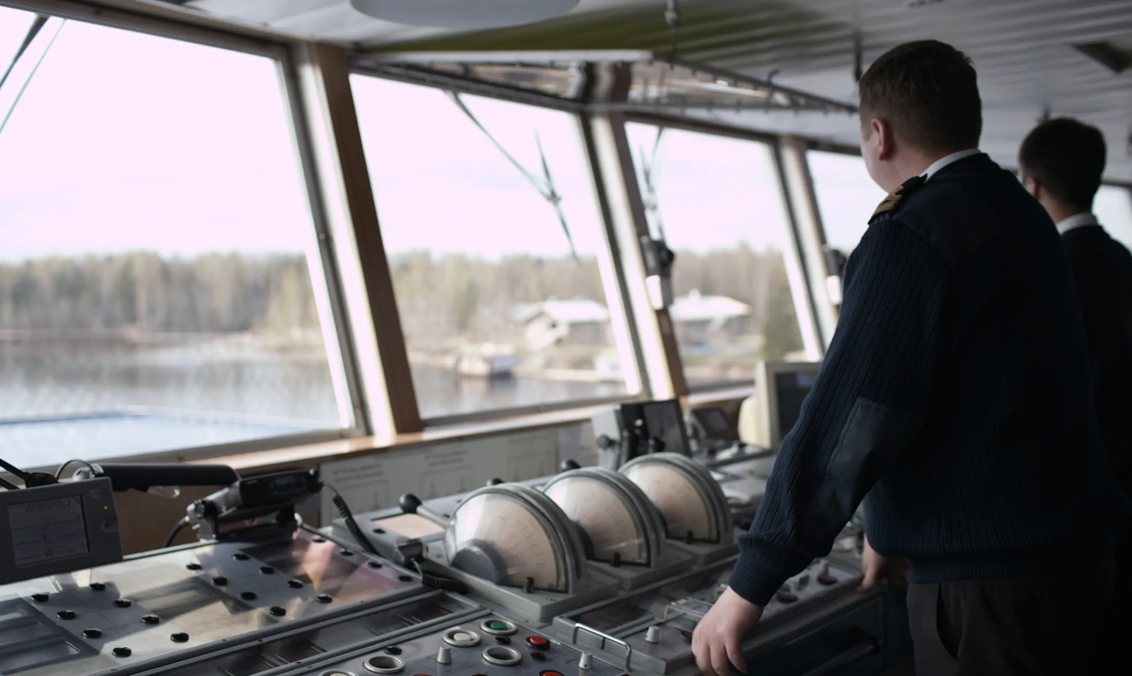 Two people in the cabin controling the ship