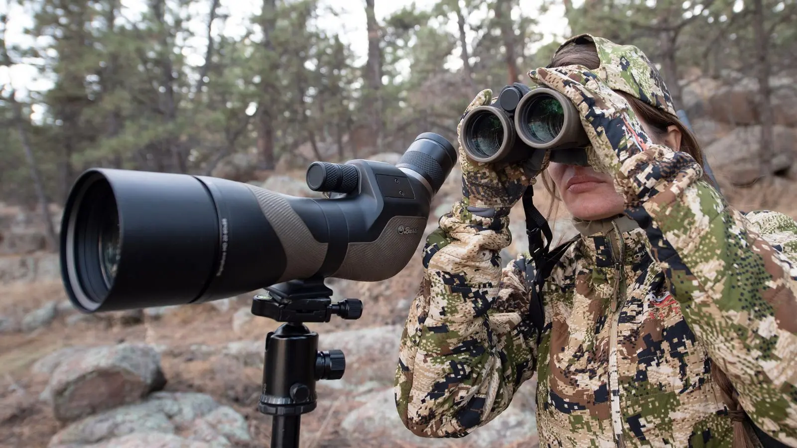 Shooter using Burris spotting scope and binoculars for long-range target observation
