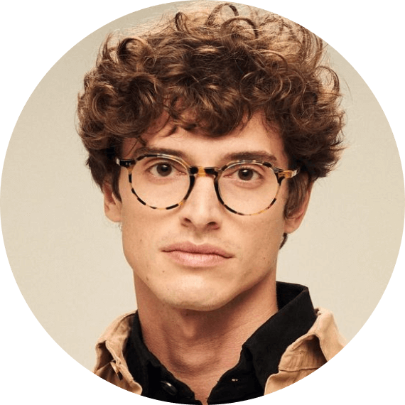 A man with glasses and a brown shirt.