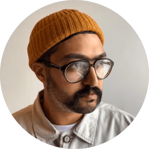 A man wearing glasses and a knitted hat.