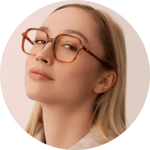 A woman wearing glasses looking up into the sky.