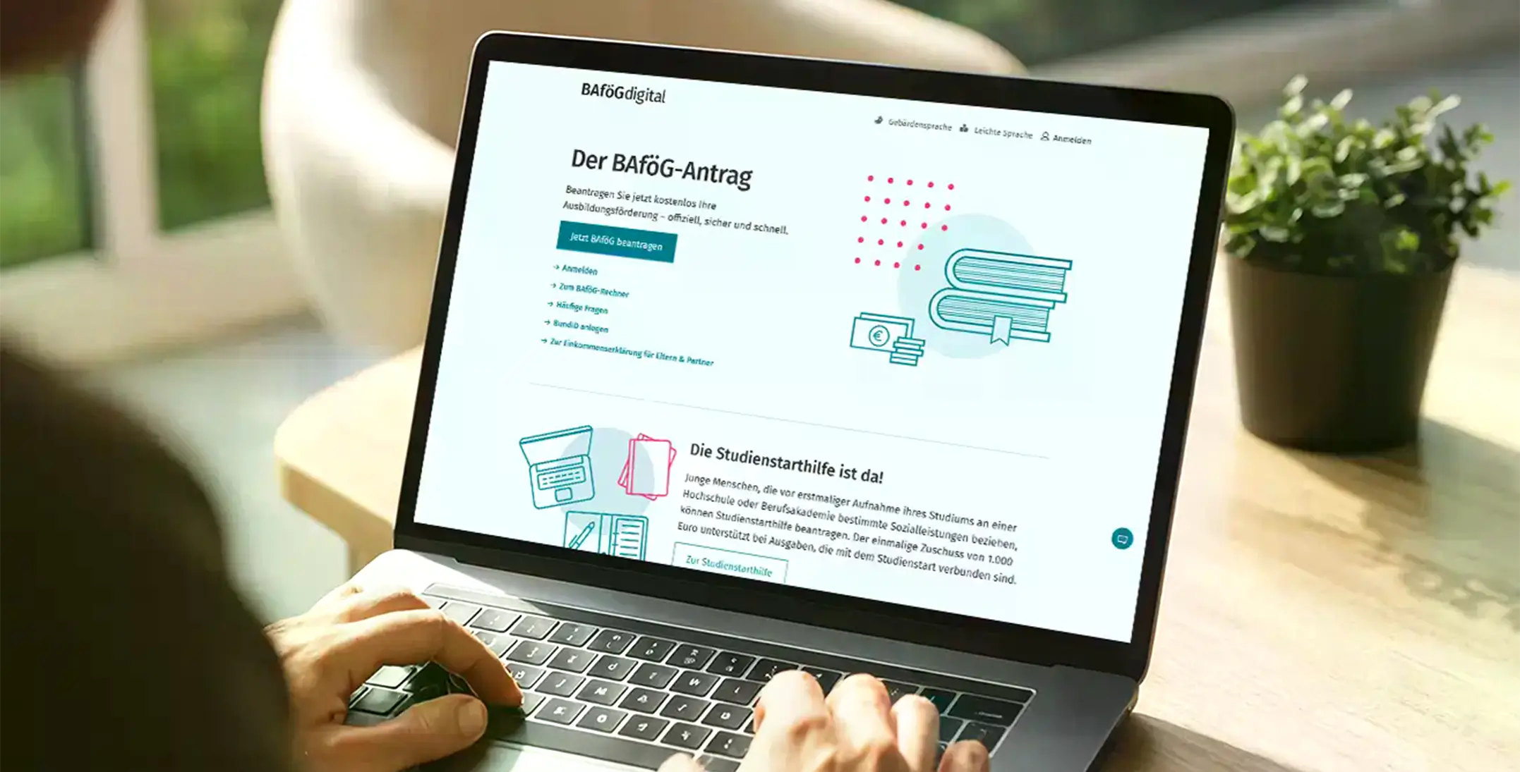 Laptopbildschirm mit geöffneter Webseite zum BAföG-Antrag und Studienstarthilfe, Hände tippen auf Tastatur.