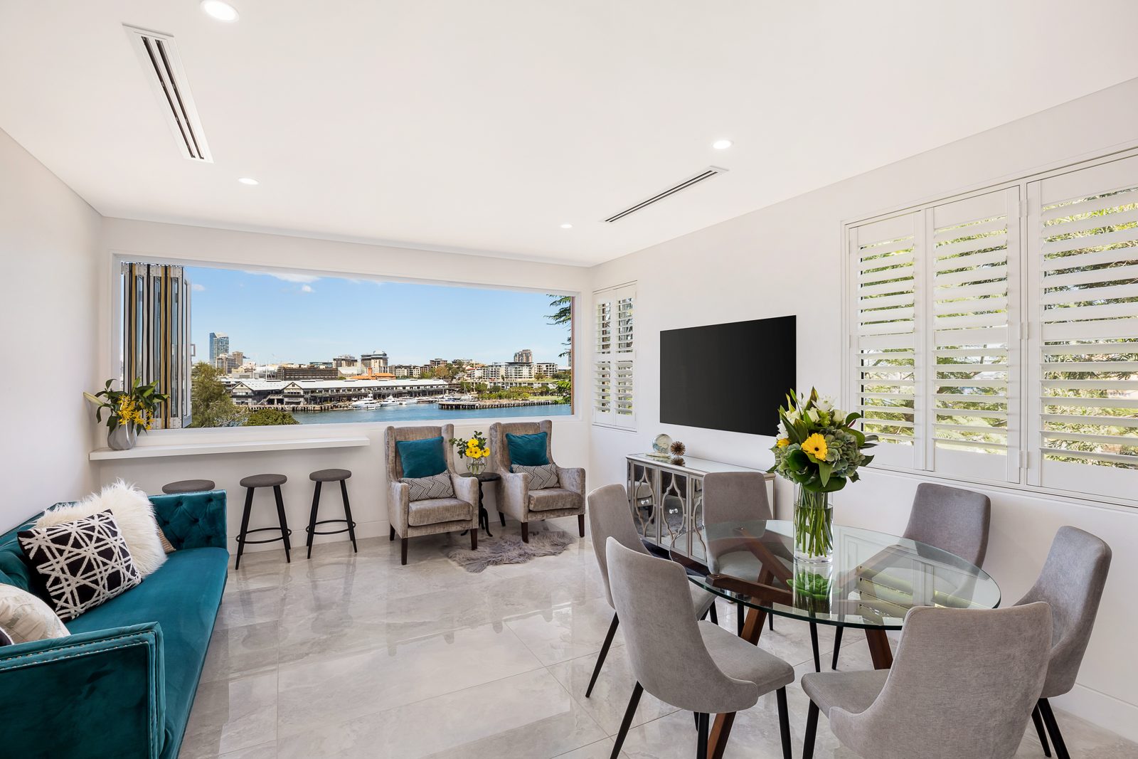 Living and dining room with water views, real estate photography by UberRE