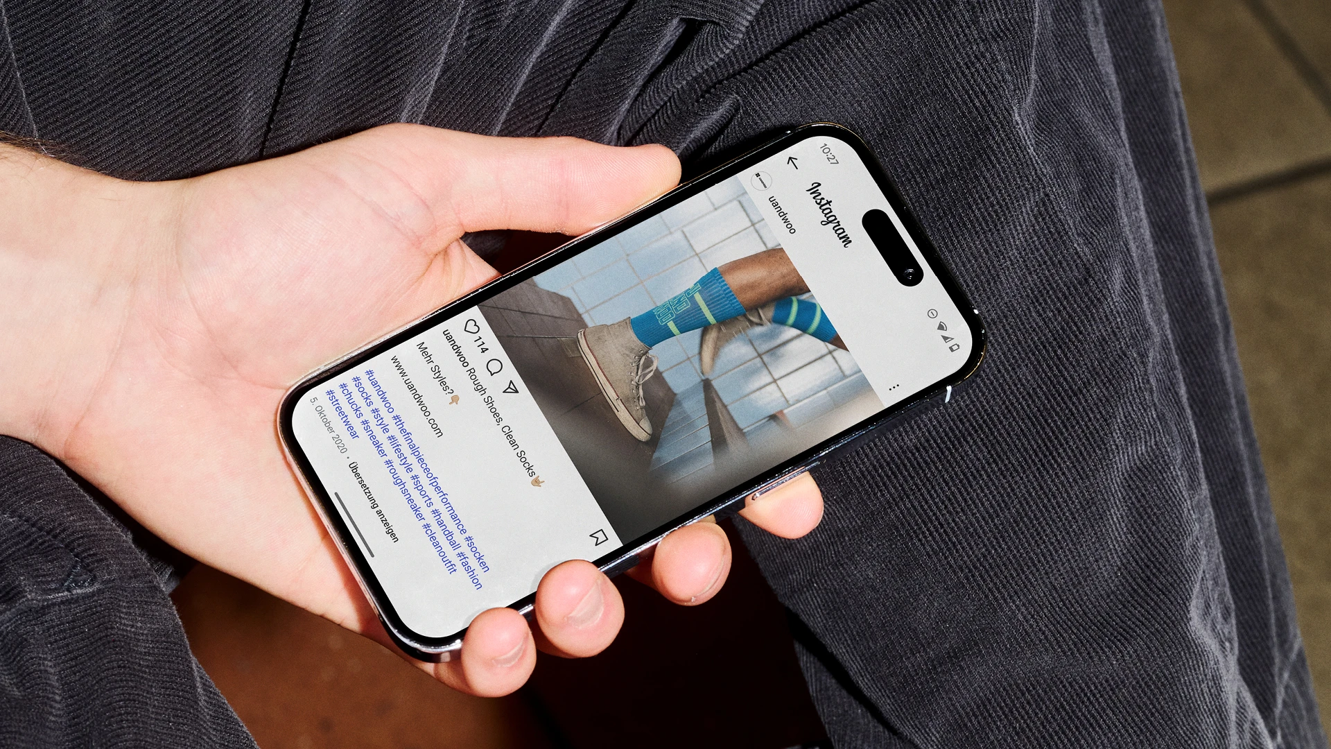 Ein UANDWOO Instagram-Beitrag auf einem Handy mit einem Sockendesign im Fokus