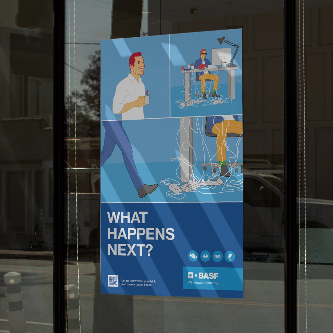 Plakat an einer Glastür mit einer BASF-Arbeitsszene und der Überschrift „What happens next?“ – ein ruhiger Kollege nähert sich einem überforderten Mitarbeiter im Kabelsalat