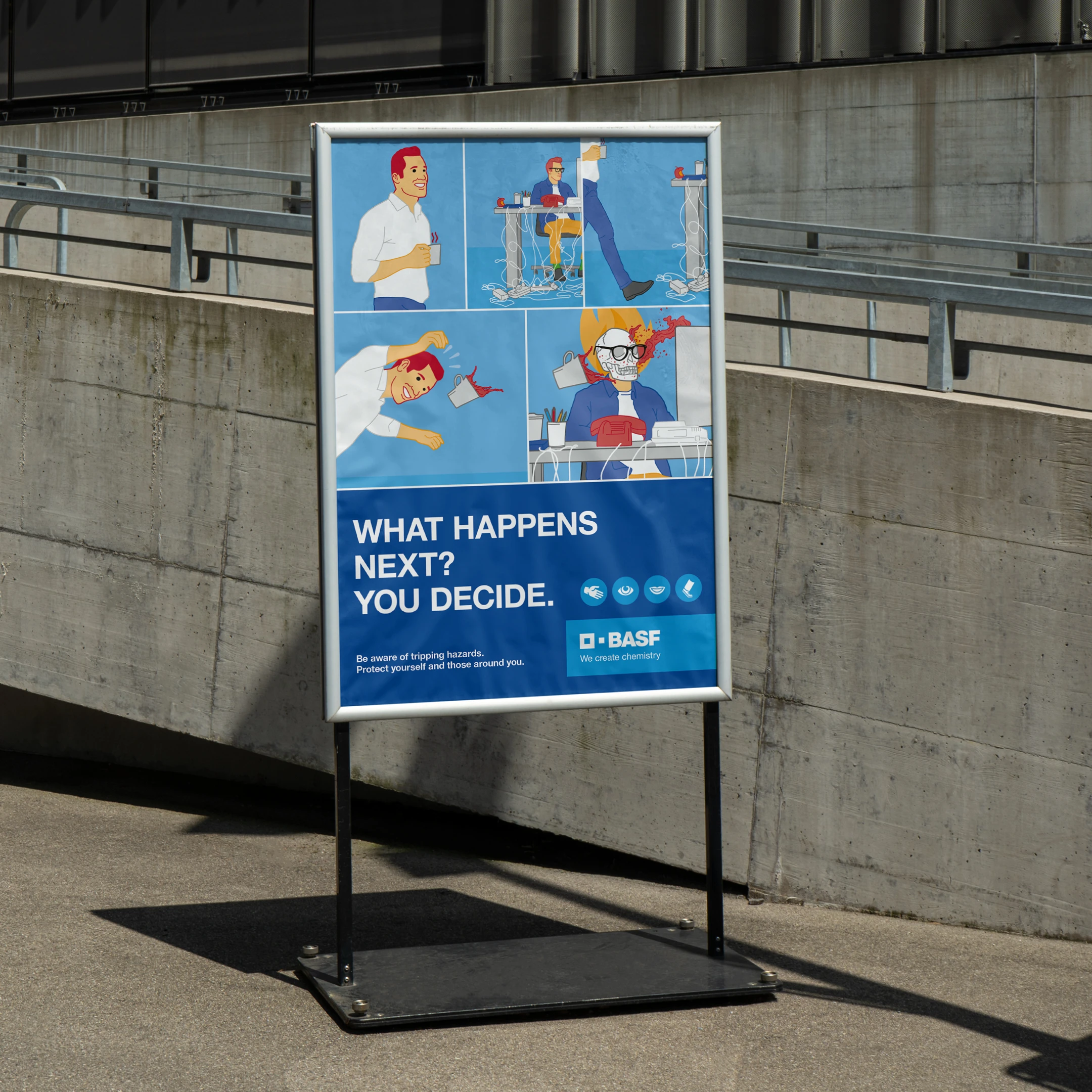 Sicherheitsposter vor einem Gebäude mit einer potenziellen Unfallszene am Arbeitsplatz und der Überschrift „What happens next? You decide.“ sowie einem BASF-Logo