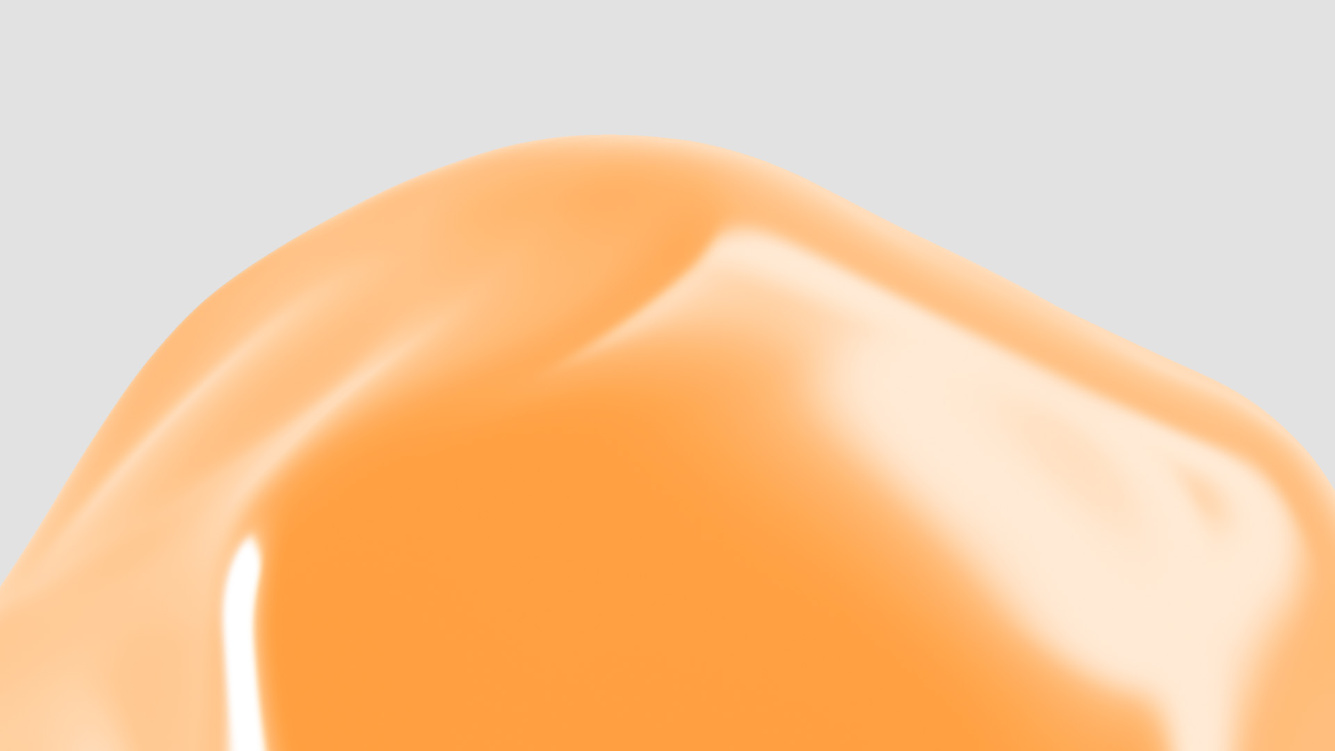 Close-up of a glossy, smooth, orange surface with highlights on a light gray background.