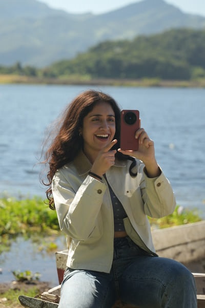Aakanksha Monga smiling in an orange dress in Cape Town
