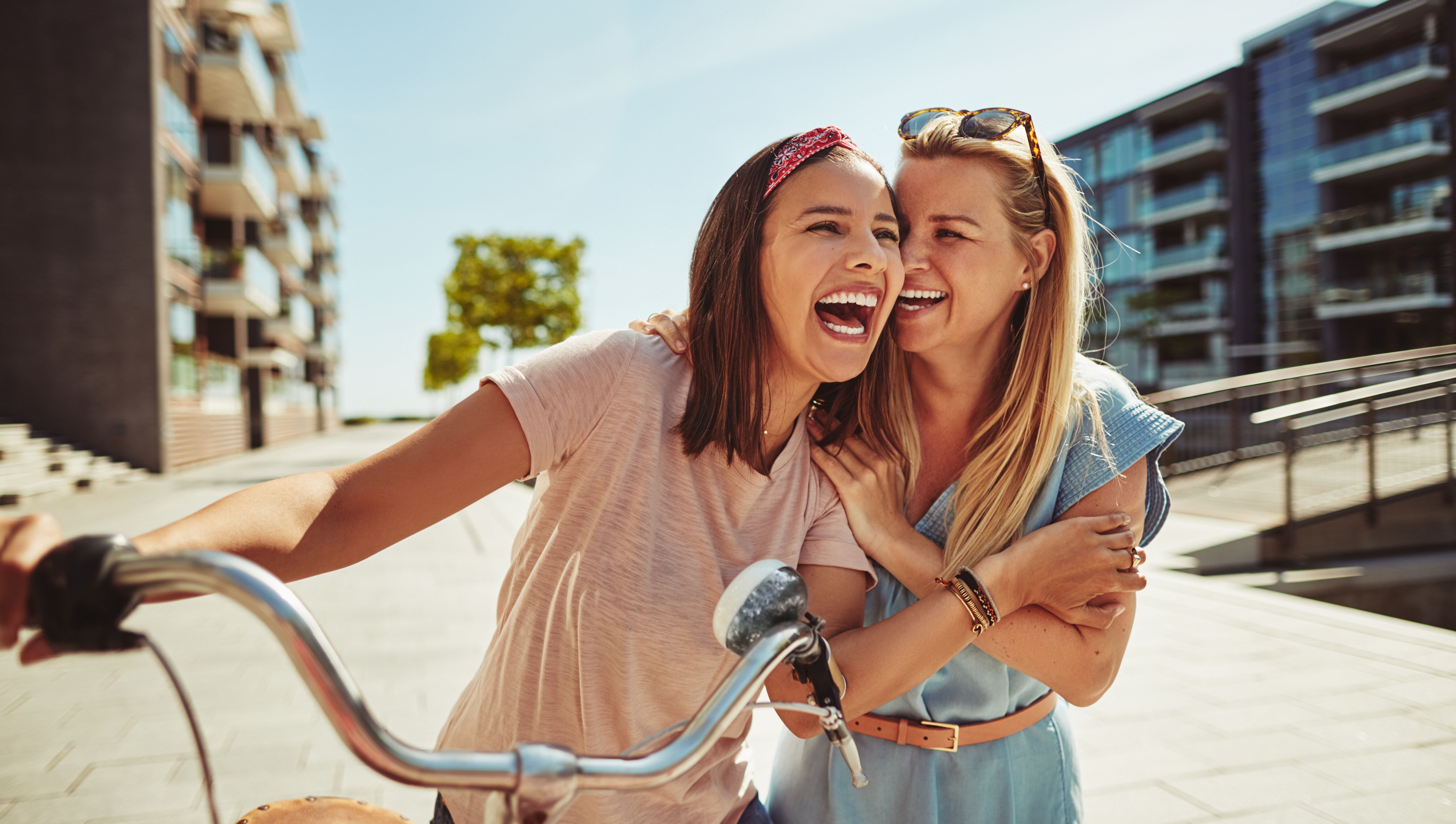 person laughing walking with friend and bike stock image