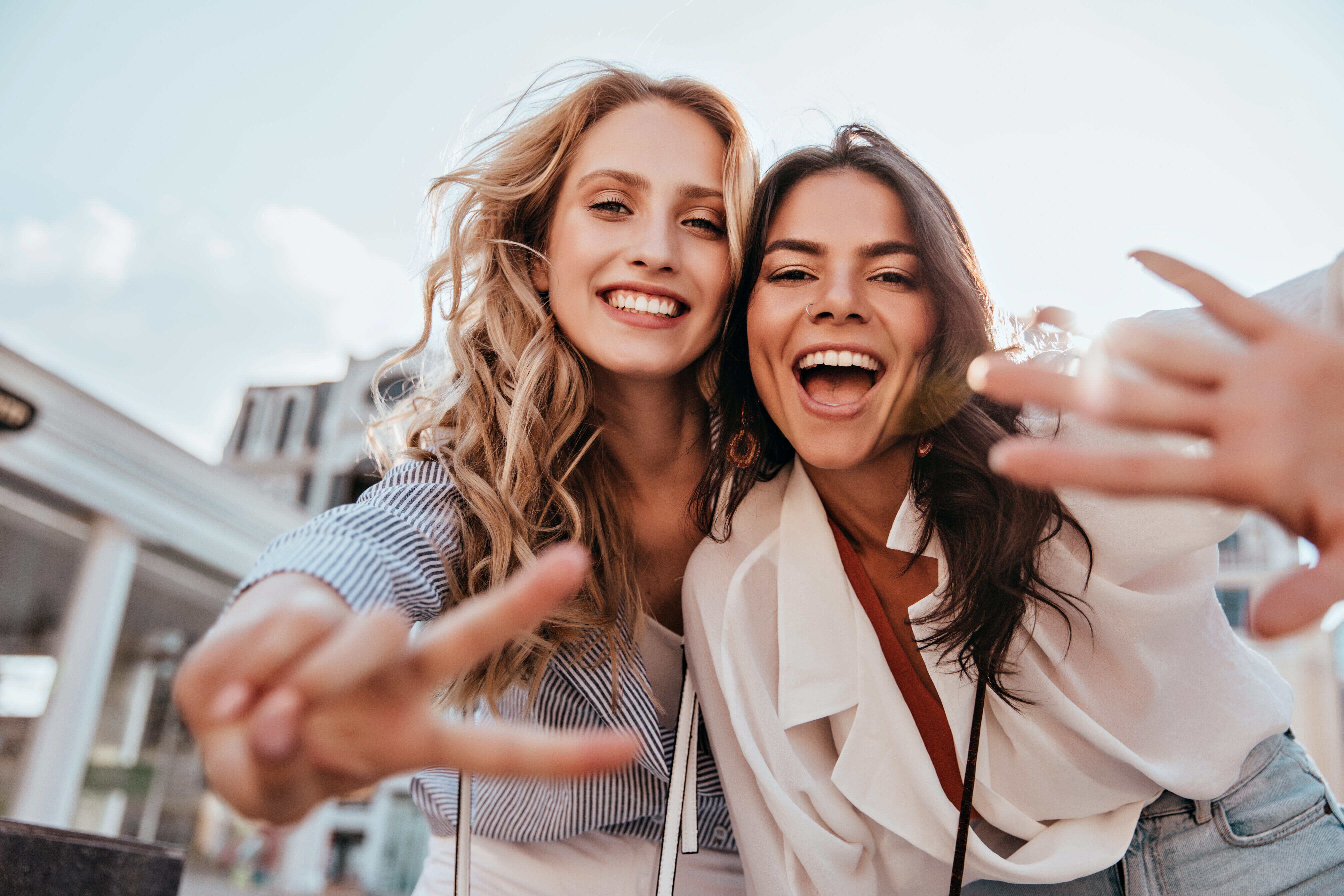 girls making peace sign stock image