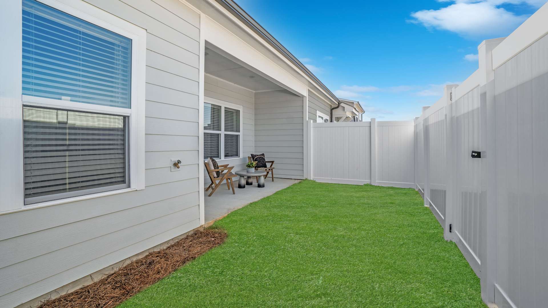 Spacious bedroom at The Cottages at Capital Circle in Tallahassee featuring a large window, and contemporary furnishings.