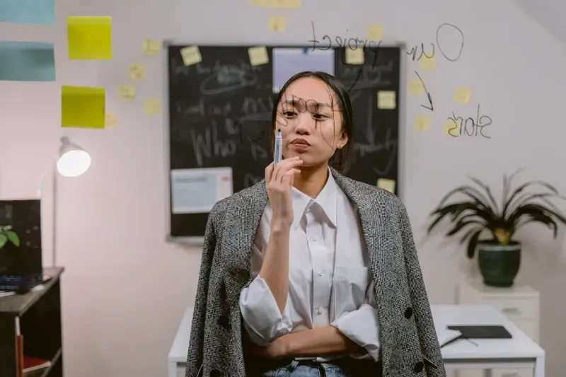 Someone thinking through a problem in front of a planning wall