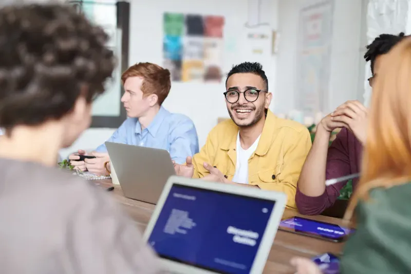 A team working through a review together around a table