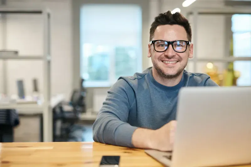 Credit analyst working at a laptop in an open office
