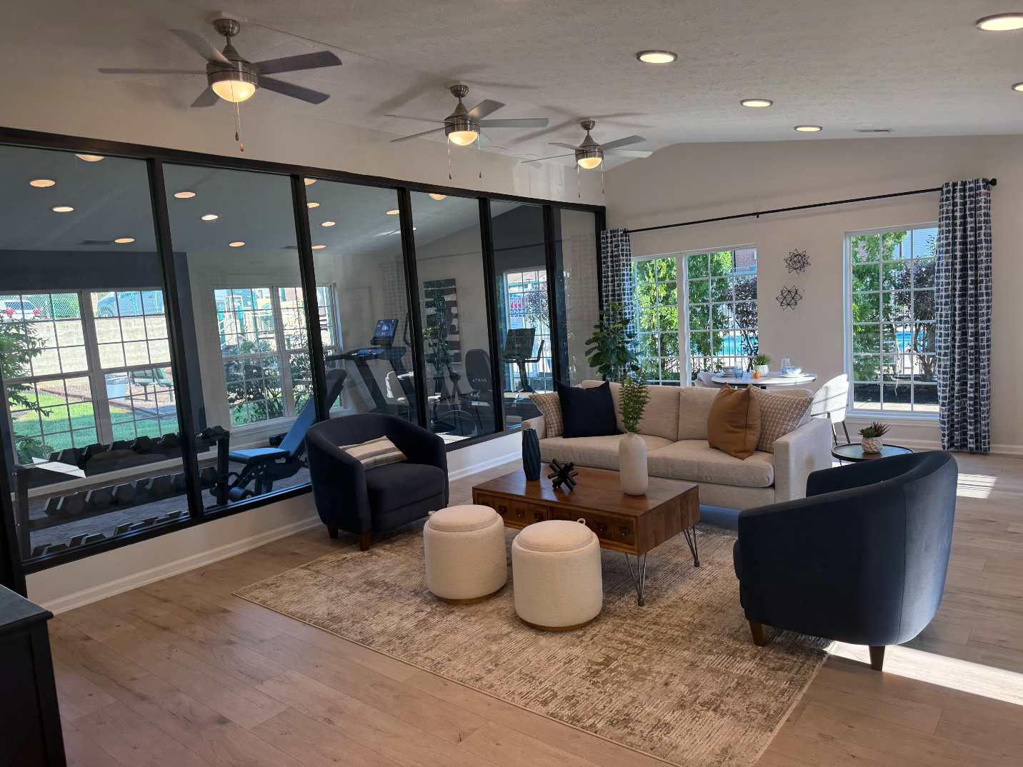 Community Lounge with sofa and view of fitness center