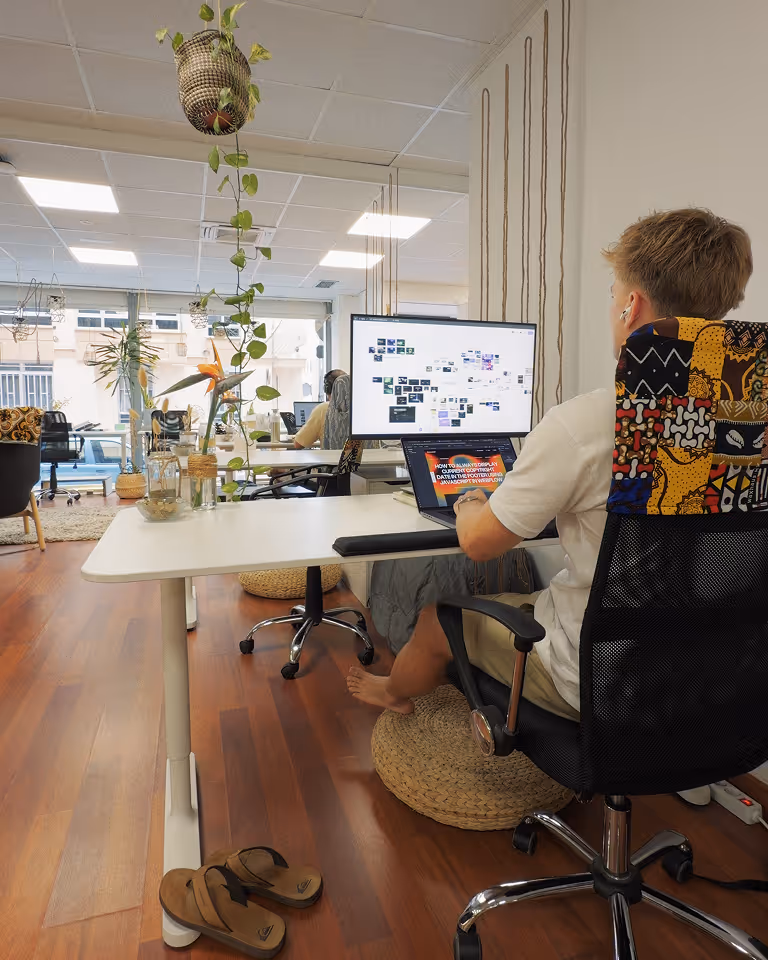 Freelance designer and Webflow developer Jaroslav Dlask working on a brand and website for a startup company from a coworking.