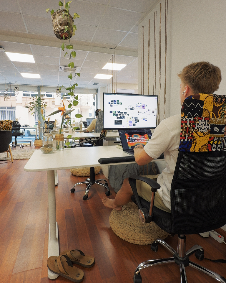 Freelance designer and Webflow developer Jaroslav Dlask working on a brand and website for a startup company from a coworking.