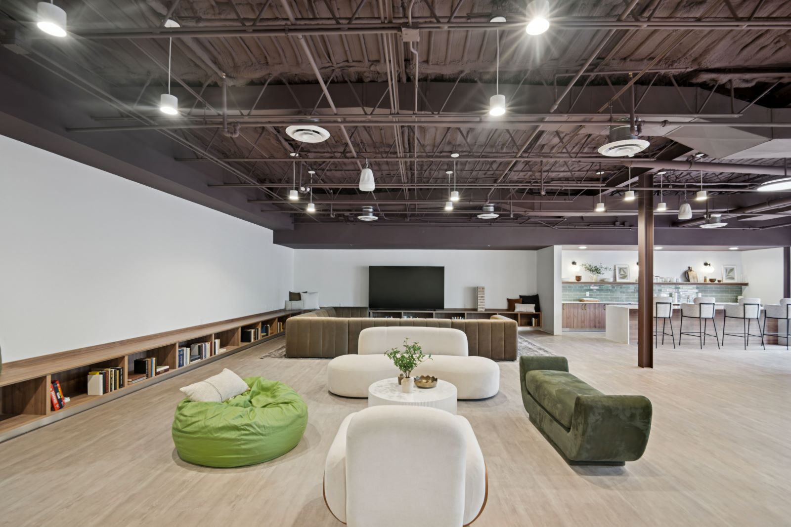Vibrant community lounge with a variety of seating, including bean bags and sofas, providing a relaxed gathering area at The Pulse in Oklahoma City, Oklahoma.