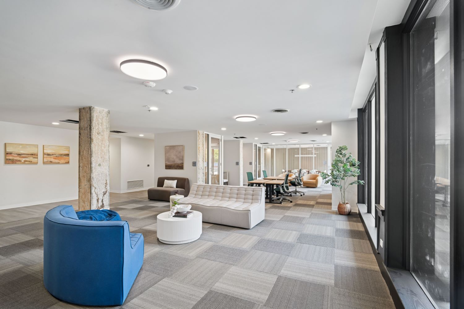 Resident co-working lounge with various seating arrangements and private study pods, offering a productive environment at The Pulse in Oklahoma City, Oklahoma.